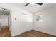 Bright bedroom featuring wood floors, white walls, closet, and a ceiling fan at 331 Barbara Cir, Belleair, FL 33756