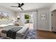 Serene bedroom with a ceiling fan, natural light, and sliding door access to the backyard at 331 Barbara Cir, Belleair, FL 33756