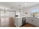 Bright, modern kitchen features white cabinetry, a breakfast bar, and stainless steel appliances at 331 Barbara Cir, Belleair, FL 33756