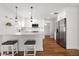 Renovated kitchen with white cabinets, quartz counters, stainless steel appliances and breakfast bar at 331 Barbara Cir, Belleair, FL 33756