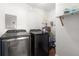 The laundry room features a side-by-side washer and dryer and a small storage shelf at 331 Barbara Cir, Belleair, FL 33756