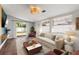 Bright living room with sliding glass doors, a comfortable seating area, and a decorative ceiling light fixture at 331 Barbara Cir, Belleair, FL 33756