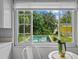 This image looks from inside the kitchen, and provides an excellent view of the backyard pool at 3409 W El Prado Blvd, Tampa, FL 33629