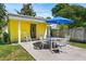 Inviting backyard patio with an umbrella, perfect for outdoor dining and relaxation at 3409 W El Prado Blvd, Tampa, FL 33629