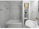 Bathroom features a tub and shower combination, tiled walls, and a convenient storage shelf at 3409 W El Prado Blvd, Tampa, FL 33629