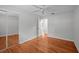 Bedroom has hardwood floors, a ceiling fan, and a mirrored closet at 3409 W El Prado Blvd, Tampa, FL 33629