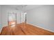 Bedroom showcasing hardwood floors, a ceiling fan, and a mirrored closet reflecting the interior at 3409 W El Prado Blvd, Tampa, FL 33629