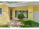 The front porch has a tile entryway and nice landscaping, as well as the house number at 3409 W El Prado Blvd, Tampa, FL 33629