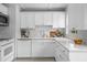 The kitchen has a white subway tile backsplash, white cabinets, and stainless appliances at 3409 W El Prado Blvd, Tampa, FL 33629