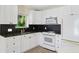 Beautifully renovated kitchen with sleek, white cabinetry and modern appliances at 3409 W El Prado Blvd, Tampa, FL 33629