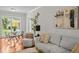 Bright living room with dining area, stylish decor, and beautiful hardwood floors at 3409 W El Prado Blvd, Tampa, FL 33629