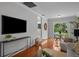 Open living room with hardwood floors, modern decor, and sliding doors to the backyard at 3409 W El Prado Blvd, Tampa, FL 33629