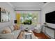 Cozy living room with a comfortable sofa, natural light, and stylish decor at 3409 W El Prado Blvd, Tampa, FL 33629