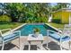 Inviting backyard pool area with comfortable seating and lush landscaping provides a relaxing oasis at 3409 W El Prado Blvd, Tampa, FL 33629