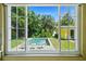 View from window of a private pool and lush backyard, creating a tranquil outdoor retreat at 3409 W El Prado Blvd, Tampa, FL 33629
