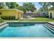 Sparkling backyard pool offers a refreshing escape with views of the well-maintained yard and outdoor seating at 3409 W El Prado Blvd, Tampa, FL 33629