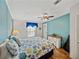 Bedroom with light blue accent wall and hardwood floors at 35026 Colony Hills Dr, Zephyrhills, FL 33541