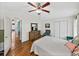 Bedroom showcasing an ensuite bathroom and hardwood flooring at 35026 Colony Hills Dr, Zephyrhills, FL 33541