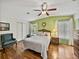Cozy bedroom with light green accent wall and hardwood flooring at 35026 Colony Hills Dr, Zephyrhills, FL 33541