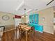 Bright dining room with a tile-inset table, custom hutch, and wood-look floors at 35026 Colony Hills Dr, Zephyrhills, FL 33541