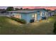 Exterior shot of a well-maintained home with manicured lawn at sunset at 35026 Colony Hills Dr, Zephyrhills, FL 33541