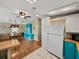 Bright kitchen and dining area with hardwood floors and a mix of white and blue cabinets at 35026 Colony Hills Dr, Zephyrhills, FL 33541