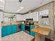 Galley kitchen with updated appliances, wood countertops, and bright blue lower cabinets at 35026 Colony Hills Dr, Zephyrhills, FL 33541