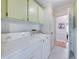 Well-lit laundry area featuring a washer and dryer and upper storage cabinets at 35026 Colony Hills Dr, Zephyrhills, FL 33541