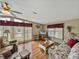 Bright living room featuring ample seating, laminate floors, and large windows that let in plenty of natural light at 35026 Colony Hills Dr, Zephyrhills, FL 33541