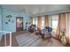 Bright sunroom featuring cozy wicker furniture and nautical decor at 35026 Colony Hills Dr, Zephyrhills, FL 33541