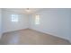 A bright bedroom with white walls, two windows and tile floors at 3815 Bowen St, New Port Richey, FL 34652