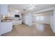 Open layout combines kitchen with essential appliances and living space, enhanced by neutral tile flooring and ample lighting at 3815 Bowen St, New Port Richey, FL 34652