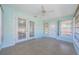 Tiled sunroom featuring double doors, a ceiling fan and lots of natural light at 3815 Bowen St, New Port Richey, FL 34652