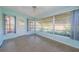 Bright sunroom with tiled floor, ceiling fan and large windows for ample natural light at 3815 Bowen St, New Port Richey, FL 34652