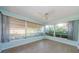 Bright sunroom with tiled floor and many windows bringing in the green outdoors at 3815 Bowen St, New Port Richey, FL 34652