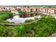 Aerial view of the community lake with a wooden boardwalk amidst lush foliage at 4323 Bayside Village Dr # 229, Tampa, FL 33615