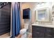 Stylish bathroom with a dark vanity, modern fixtures, and a shower featuring navy blue tile at 4323 Bayside Village Dr # 229, Tampa, FL 33615