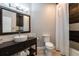 Well-lit bathroom with a dark wood vanity, vessel sink, white subway tile, and shower-tub combination at 4323 Bayside Village Dr # 229, Tampa, FL 33615