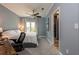 Comfortable bedroom with a ceiling fan, carpet and a desk for working from home near the bathroom at 4323 Bayside Village Dr # 229, Tampa, FL 33615