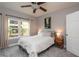Cozy bedroom with plush carpet, a ceiling fan, neutral tones and natural light from large window at 4323 Bayside Village Dr # 229, Tampa, FL 33615
