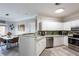 Bright kitchen features white cabinets, stainless steel appliances, and modern countertops at 4323 Bayside Village Dr # 229, Tampa, FL 33615