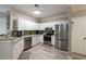 Modern kitchen featuring white cabinets, stainless steel appliances, and wood floors at 4323 Bayside Village Dr # 229, Tampa, FL 33615
