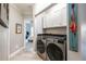 Convenient laundry area featuring a stacked washer and dryer, cabinetry, and flamingo art at 4323 Bayside Village Dr # 229, Tampa, FL 33615