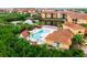 Aerial view of the community pool with a covered seating area and sun loungers at 4323 Bayside Village Dr # 229, Tampa, FL 33615