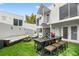 A modern home with a backyard area featuring comfortable seating, and lush landscaping at 4522 W North B St, Tampa, FL 33609