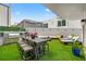A backyard features an outdoor kitchen, ample seating, and lush greenery for relaxation and enjoyment at 4522 W North B St, Tampa, FL 33609