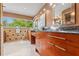 Primary bathroom featuring double vanity with granite counters, modern sinks, and a large picture window at 4522 W North B St, Tampa, FL 33609