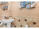 Elegant powder room featuring a pedestal sink, designer tile, and decorative wall art for added style at 4522 W North B St, Tampa, FL 33609