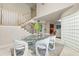Elegant dining area featuring a glass table, unique chairs, and a staircase at 4522 W North B St, Tampa, FL 33609