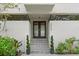 Elegant home entrance featuring double doors, landscaping and minimalist design at 4522 W North B St, Tampa, FL 33609